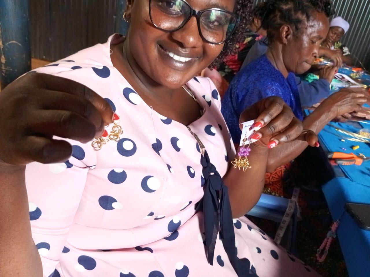 Senior woman proudly displaying handmade jewelry from our artisan workshop
